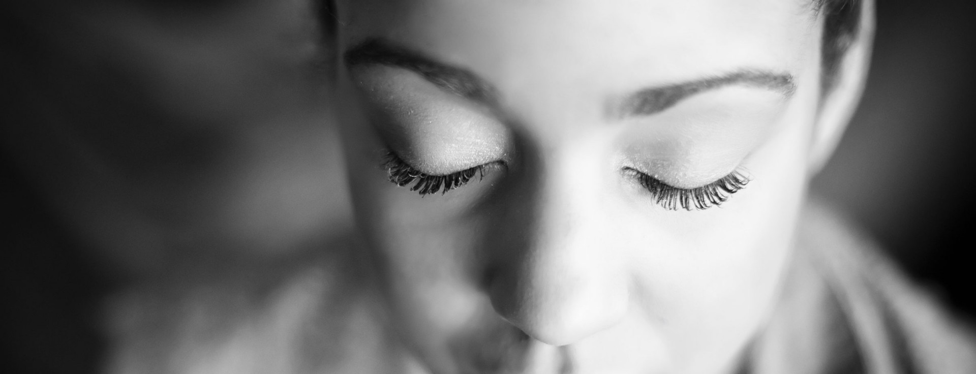Close-up of a calm face with eyes gently closed — the inward turn of attention