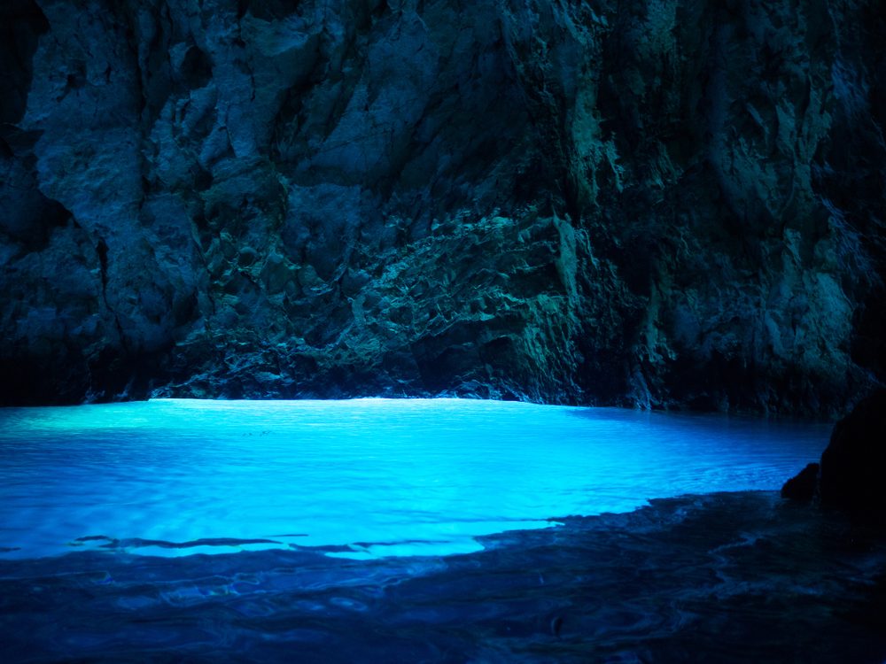 Glowing blue sea cavern grotto — hypnotherapy case study of a psychic medium who found an inner well of stillness