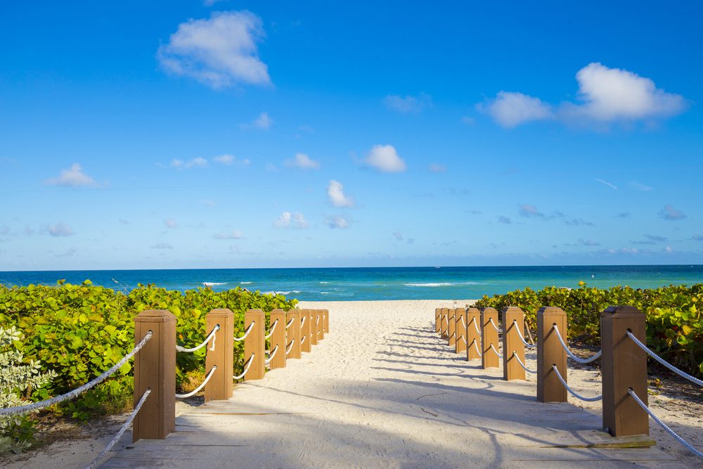 Boardwalk leading to the ocean in Miami Beach — the in-person home of Innergenius Hypnosis